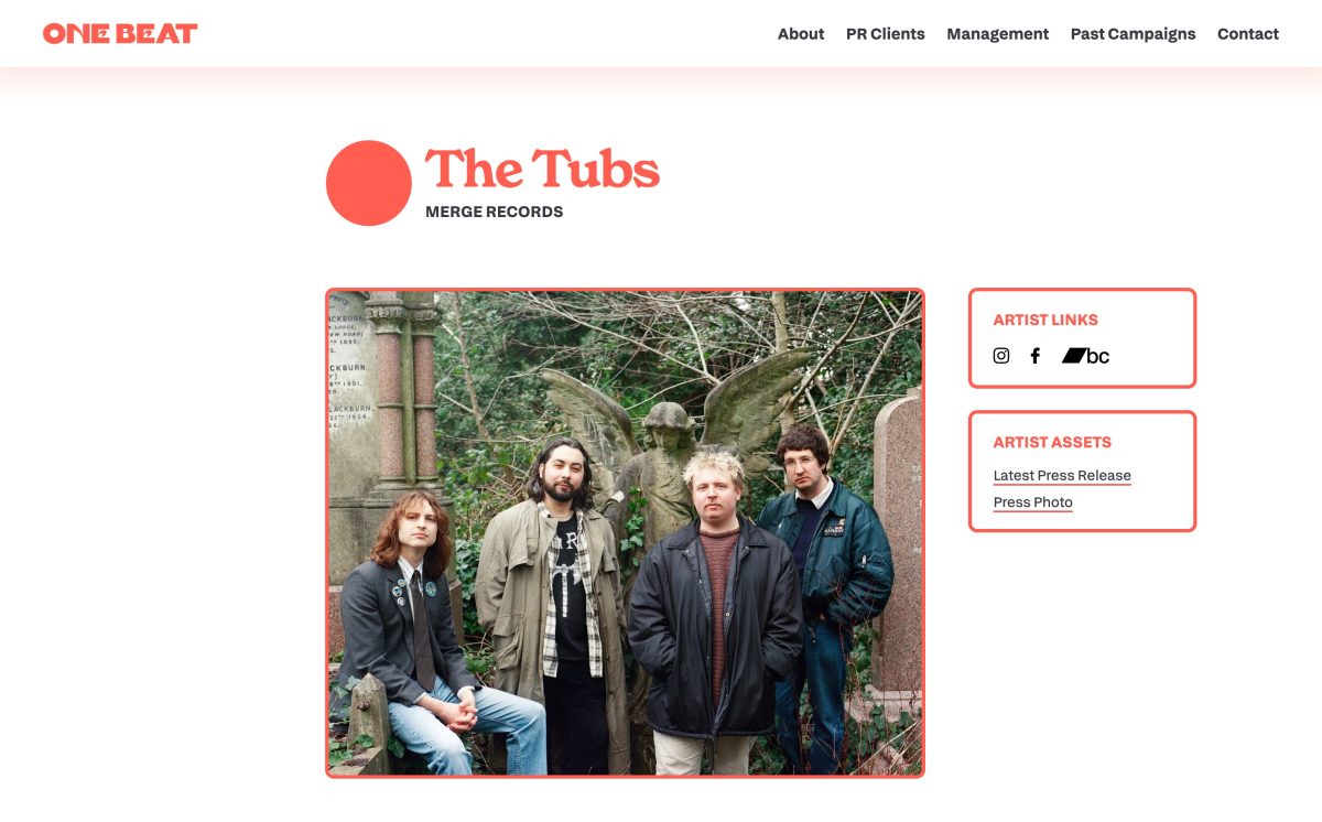 A page from the One Beat PR website, viewed on a desktop screen. In the top-left corner is the site's logo, in a pastel red, thick, all-caps serif with a seventies slant. Directly opposite the logo on the right-hand side is the site menu, containing links to 'About', 'PR Campaigns', 'Management', 'Past Campaigns' and 'Contact'. The words 'The Tubs' sits below in a large, chunky, seventies-ish, pastel-red serif font, alongside a circular red shape, and above the words 'Merge Records' in a much smaller, black bold uppercase sans-serif. Below this is a landscape photograph with a red border, that depicts four people in a graveyard, staring into the camera with a mixture of nonchalance and amusement. Alongside the photo, are two boxes with red, rounded borders, headed 'Artist Links' and 'Artist Assets'.