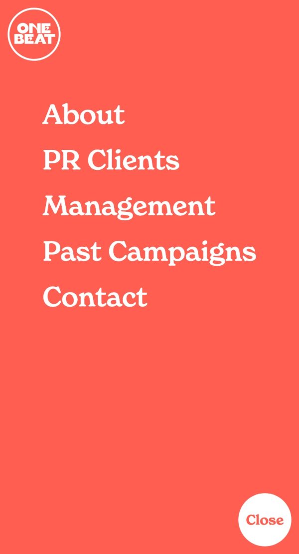 The mobile menu from the One Beat PR website. It has a pastel-red background and white text. In the top-centre is the site's logo, in a pastel red, which consists of a white circle with a red outline, within which is the text 'One Beat' in a thick, all-caps serif with a seventies slant. Underneath is the text 'About, PR Clients, Management, Past Campaigns, Contact' in a large chunky, slightly seventies serif font. In the bottom-right corner is a white circle with red text containing the word 'Close'.